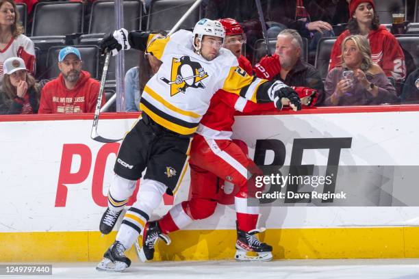 Ryan Poehling of the Pittsburgh Penguins body checks Jonatan Berggren of the Detroit Red Wings during the first period of an NHL game at Little...