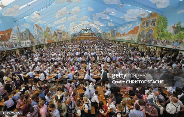 Visitors of the Oktoberfest beer festival crowd in a tent at the Theresienwiese fairground in Munich, southern Germany, September 20, 2010. The...
