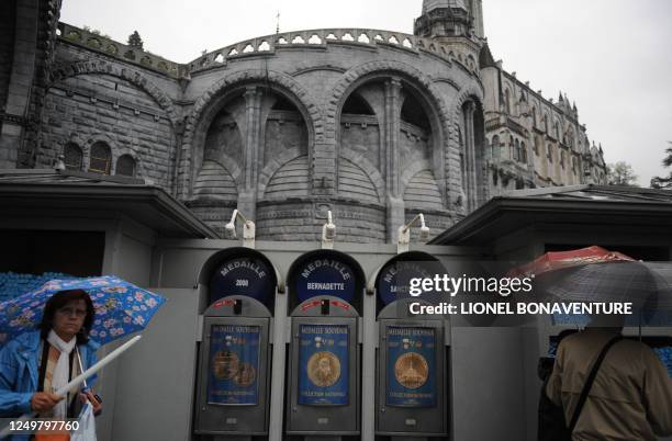 Pilgrims stand by donation machines at the Sanctuary of Lourdes on September 11, 2008 ahead of the visit of Pope Benedict XVI who will commemorate...