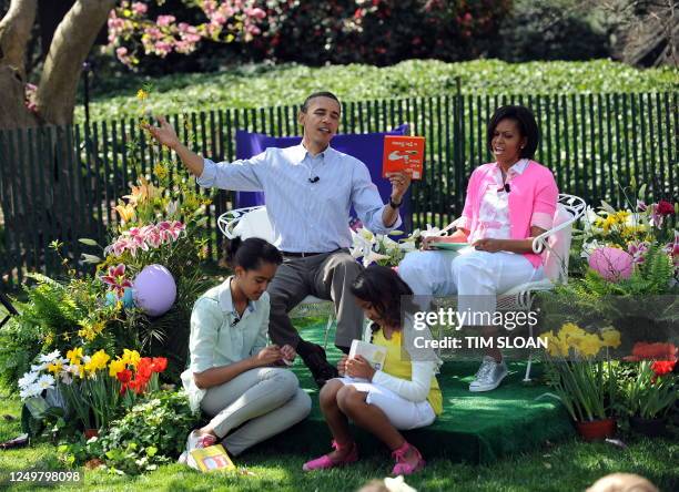 President Barack Obama prepares to read "Green Eggs and Ham" with First Lady Michelle Obama , Malia and Sasha on the South Lawn of the White House...