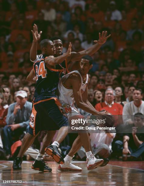 Jermaine Harper and Travis Watson of the University of Virginia Cavaliers attempt to block Drew Nicholas, Guard for the University of Maryland...