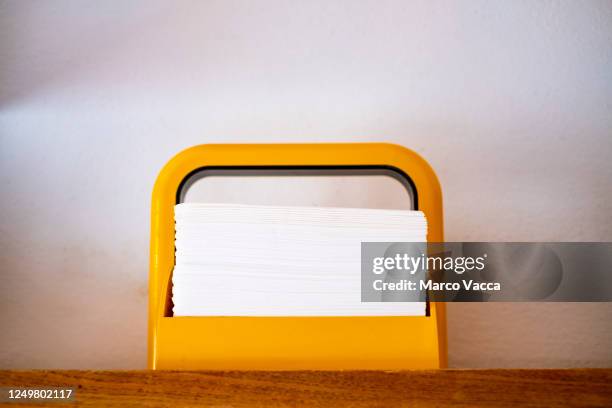 a yellow napkin holder - napkin holder stock pictures, royalty-free photos & images