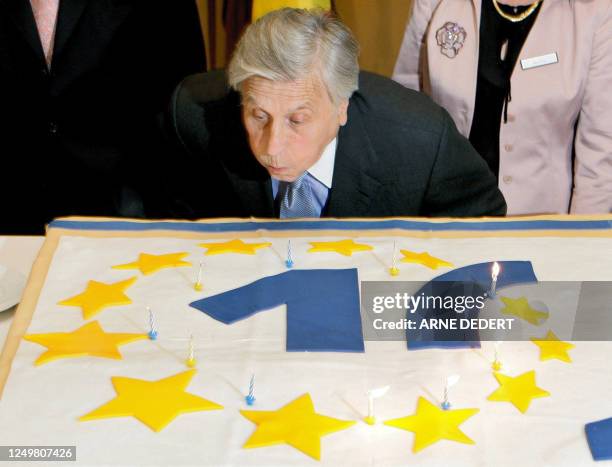 European Central Bank President Jean-Claude Trichet blows the ten candles of a birthday cake on June 2, 2008 during festivities to celebrate the...