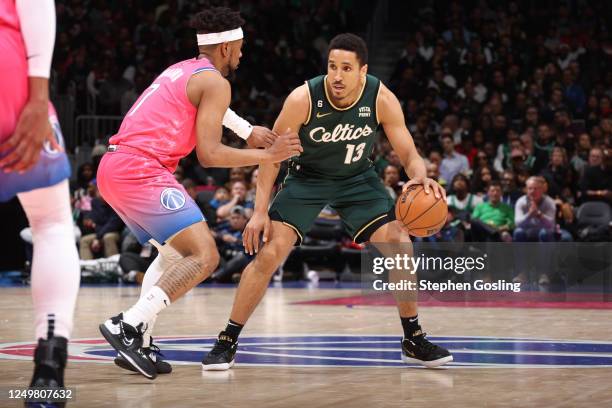 Malcolm Brogdon of the Boston Celtics dribbles the ball during the game against the Washington Wizards on March 28, 2023 at Capital One Arena in...