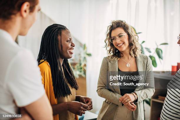 multi ethnic group of business people working together in small modern office - small meeting stock pictures, royalty-free photos & images