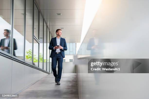 young businessman with cell phone in the city on the - looking around stock pictures, royalty-free photos & images