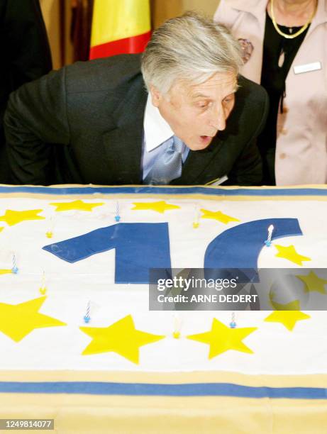 European Central Bank President Jean-Claude Trichet blows the ten candles of a birthday cake on June 2, 2008 during festivities to celebrate the...