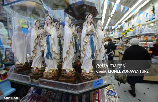 Statues of the Virgin Mary are displaced in a store in Lourdes on September 11, 2008 ahead of the visit of Pope Benedict XVI who will commemorate...