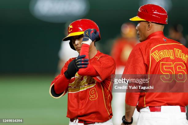 Ning Li of Team China reacts after hitting a single in the fourth inning during Game 5 of Pool B between Team China and Team Australia at Tokyo Dome...