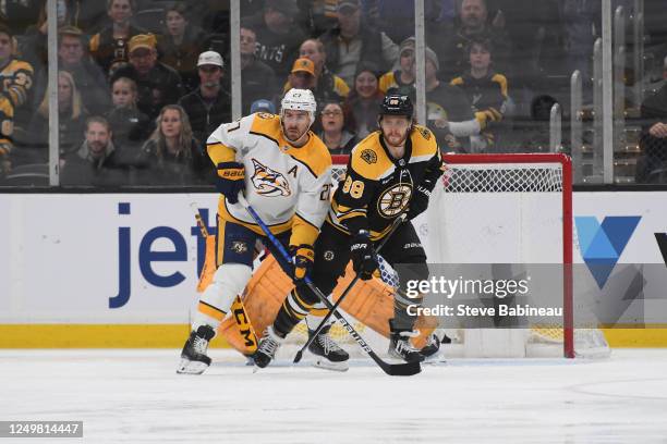 Ryan McDonagh of the Nashville Predators against David Pastrnak of the Boston Bruins at the TD Garden on March 28, 2023 in Boston, Massachusetts.
