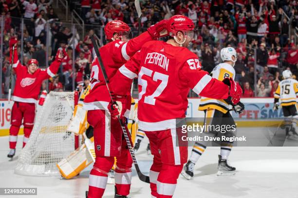 David Perron of the Detroit Red Wings celebrates his goal against the Pittsburgh Penguins with Andrew Copp of during the third period of an NHL game...
