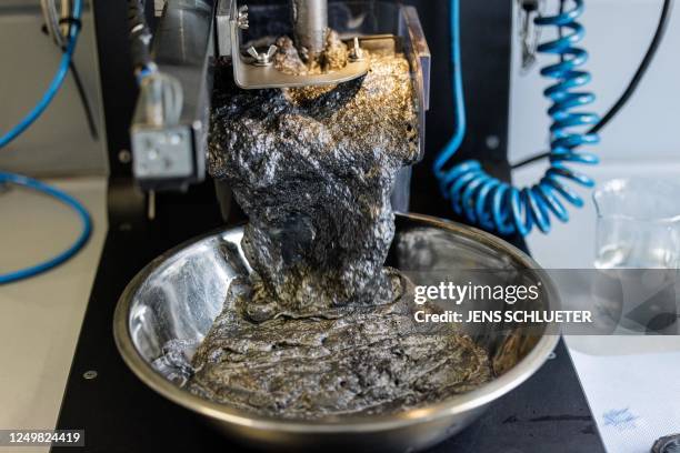 Recycled graphite attached to air bubbles and rising to the surface of the flotation cell at the graphit recycling system in a laboratory of the...