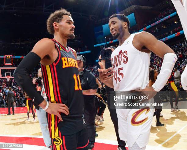 Donovan Mitchell of the Cleveland Cavaliers and Trae Young of the Atlanta Hawks embrace after the game on March 28, 2023 at State Farm Arena in...