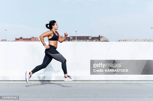young woman running training in the city - marathon stock-fotos und bilder
