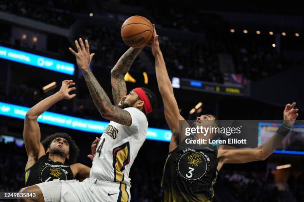 Jordan Poole of the Golden State Warriors goes for a block as Brandon Ingram of the New Orleans Pelicans drives to the basket during the third...