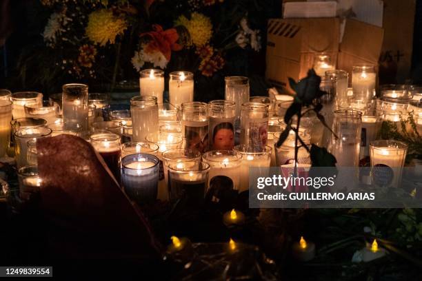 Candles are lit during a vigil outside Mexican immigration facilities where at least 38 migrants died in a fire, in Ciudad Juarez, Chihuahua state,...