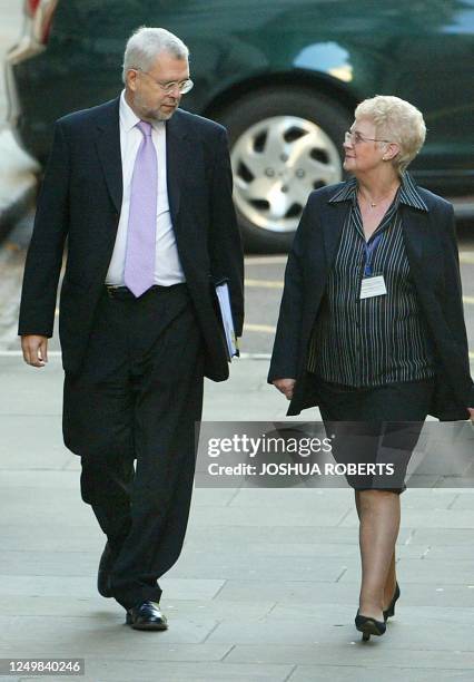 Chairman Gavyn Davies and an unidentified woman arrive for the Hutton Inquiry at the Royal Courts of Justice in London 24 September, 2003 after being...