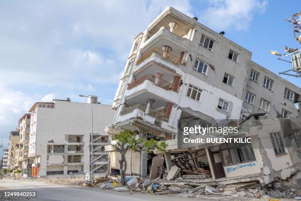 This photograph taken in Hatay on March 28 shows a damaged house bearing a graffiti inscription which reads "we will come back", after a...
