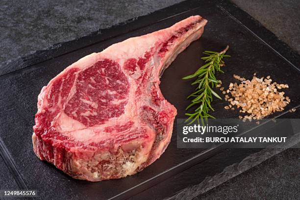 tomahawk steak raw - tomahawk stock pictures, royalty-free photos & images