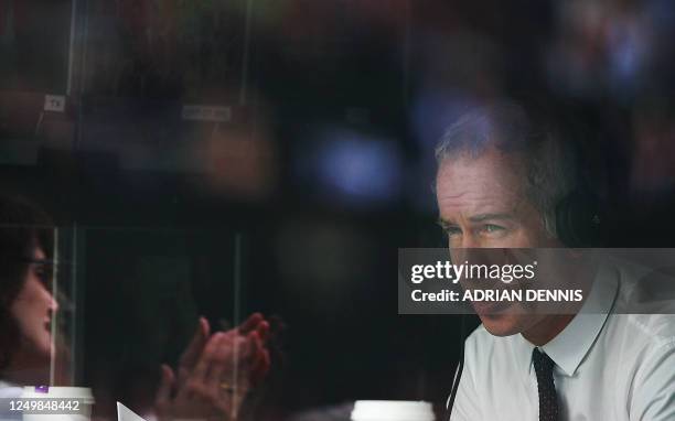 Television commentator and former Wimbledon champion John McEnroe is seen as Serena Williams of USA plays Daniela Hantuchova of Slovakia during the...