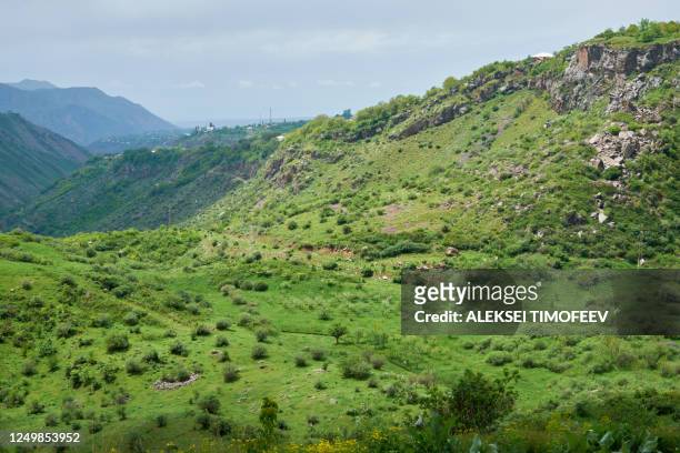 view of a green valley in the mountains on a sunny day with clouds in the sky. - armenia country stock pictures, royalty-free photos & images