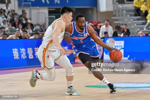 Jordan Crawford R of Sichuan Blue Whales breaks through during the 39th round match between Shanxi Loongs and Sichuan Blue Whales at 2022-2023 season...