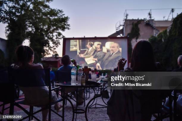 People watch a movie at Zephyros open-air cinema as the measures against coronavirus ease on June 15, 2020 in Athens, Greece. The country removed...