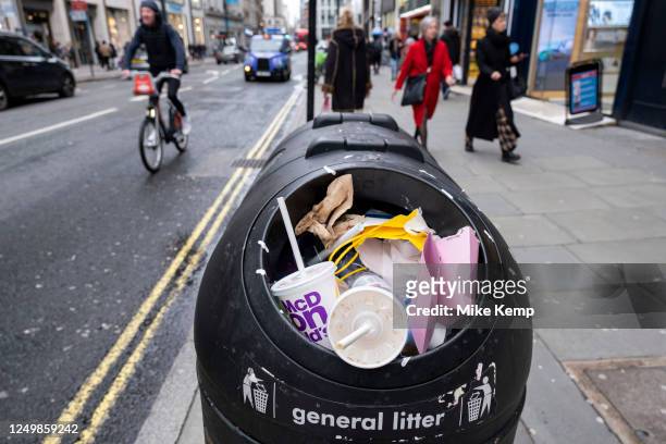 Packaging from take away food and drinks companies piled up on top of an overflowing street rubbish bin on 26th March 2023 in London, United Kingdom....