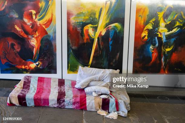 Matress and bedding and some small amounts of food owned by a homeless rough sleeper occupies a space beside public art illustrations in the...