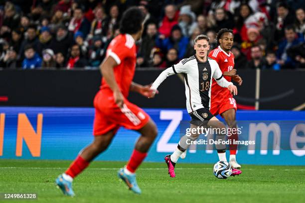 Renato Tapia of Peru, Florian Wirtz of Germany and Andre Carillo of Peru battle for the ball during an international friendly match between Germany...