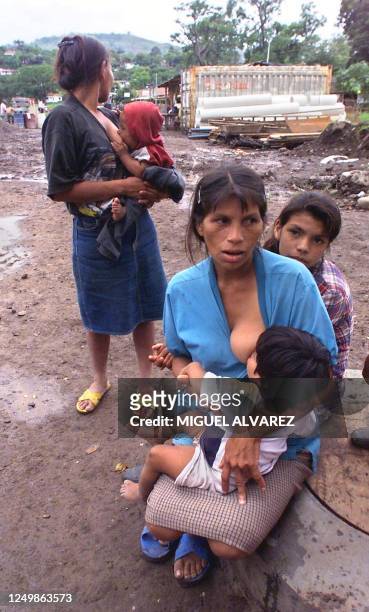 Farmers Maria Luisa Espinoza , 32 years old, and Maria Cano, 26 years old, breastfeed their children as they await entry into a temporary shelter in...