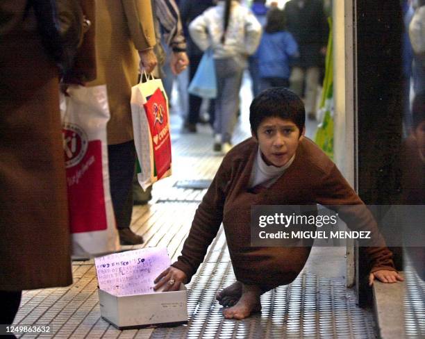 Child seeks alms on the street 20 July 2001 in Buenos Aires, Argentina. Argentina has experienced nearly three years of economic recession, with...