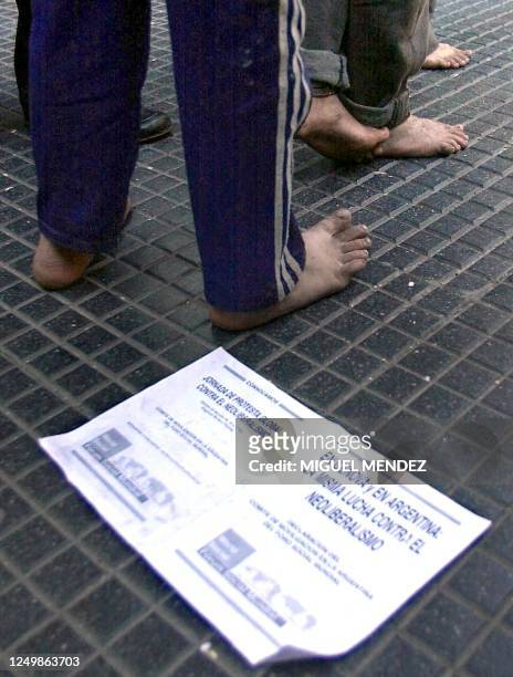 Barefoot children watch a theater performance on the streets of Buenos Aires against the G8 meeting in Genova, Italy, 20 July 2001. Argentina has...
