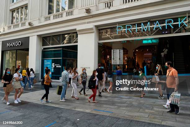 Shoppers queue in a line to enter the Primark store on June 15, 2020 in Madrid, Spain. Primark reopens to the public after its closure in the middle...