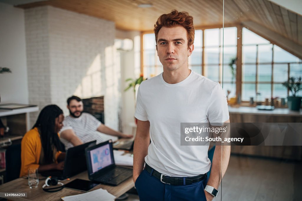 Redhead man with colleagues in office