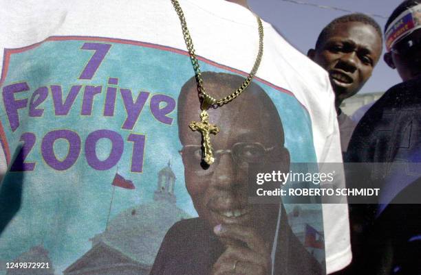 Man wears a t-shirt showing a photo of Haitian president-elect Jean-Bertrand Aristide in Cite Soleil, one of Port-Au-Prince's poorer quarters 06...