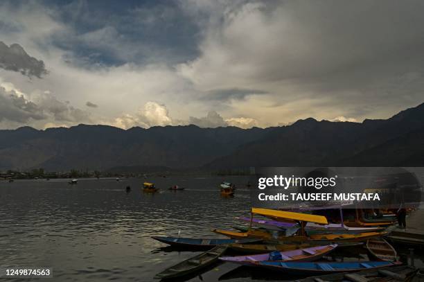Tourists enjoy boat rides at Dal lake in Srinagar on March 29, 2023.