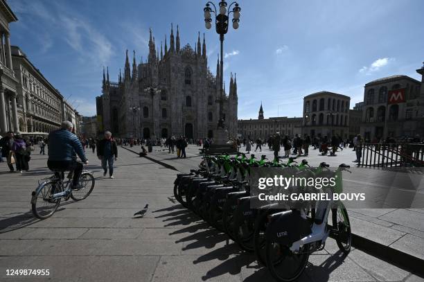 Electric bicycles from the Lime electric scooter and bicycle sharing service are parked in Piazza Duomo in Milan on March 29, 2023.