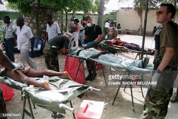 Army nurses and doctors examine Haitian patients from Port-au-Prince poor neighborhoods 28 July 1999 at the temporary medical center set up in the...