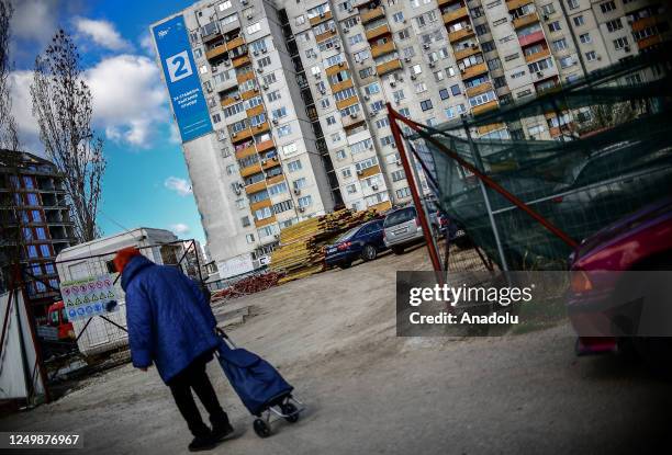 Woman walks in front of a campaign billboard of the GERB party on a residential building in Sofia, Bulgaria on March 29, 2023. Bulgaria is preparing...