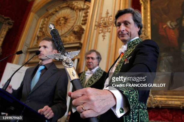 French journalist and former head of French public television group France Televisions, Patrick de Carolis poses with his sword at the Invalides ,...
