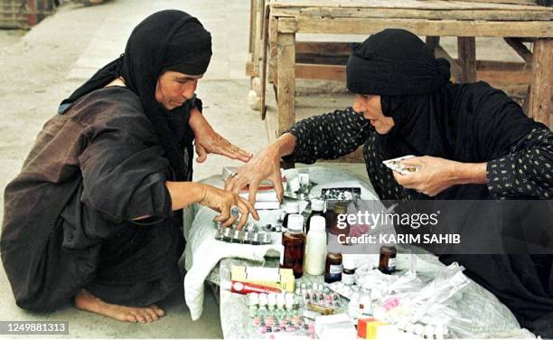 Iraqi women sell medicine on the black market in Baghdad 25 May 1999. The UN Security Council has renewed the sixth phase of the "oil-for food"...