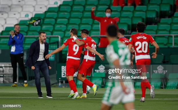 Diego Martinez, manager of Granada celebrates with Roberto Soldado of Granada after his late equaliser during the Liga match between Real Betis...