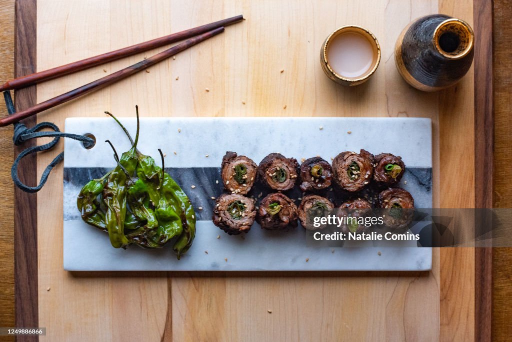 Top-down view of Negimaki with grilled shishito peppers