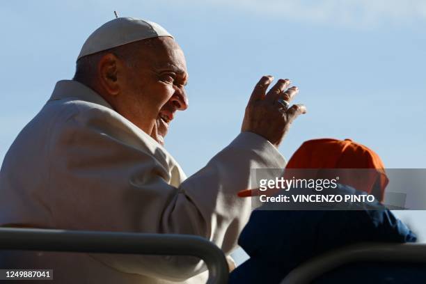 Pope Francis gestures as he arrives in the popemobile car on March 29, 2023 for the weekly general audience at St. Peter's square in The Vatican. -...