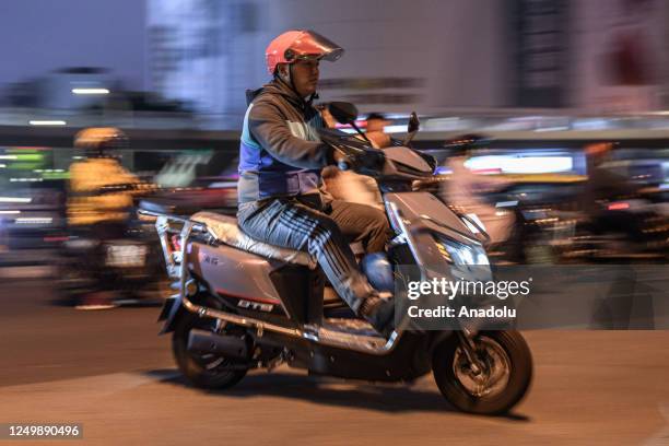 Citizen rides an electric bicycle on the street on March 16 in Haikou, Hainan Province of China. One of the Chinese towns with the highest...