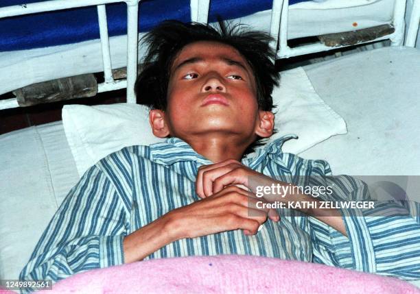 Severly malnourished 15-year-old lies in a hospital bed in Wonsan City 22 October in the famine-stricked North Korea. School aged children are not...