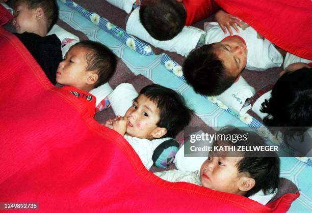 Young children nap in a baby home in Wonsan City 22 October in the famine-stricked North Korea. The health status of children below the age of six...