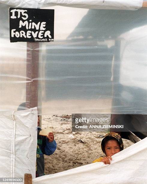 Young girl peers through the plastic sheeting of a make-shift home at Lost City, Tafelsig in Mitchell's Plein, Cape Town on 4 May, as the Cape Town...