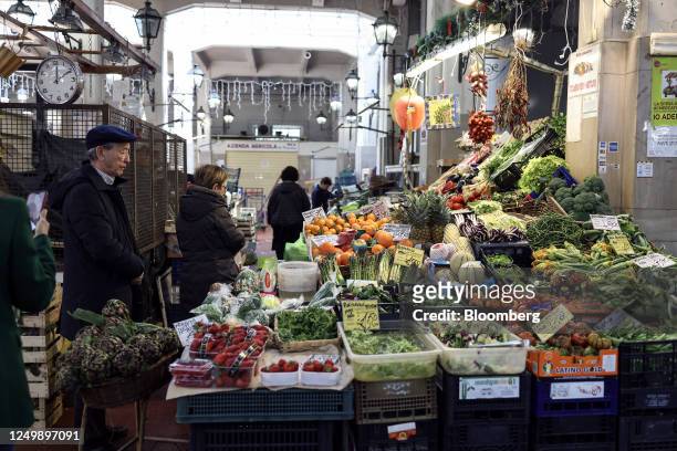 Customers shop for fruit and vegetable produce at an indoor market in downtown Rome, Italy, on Tuesday March 28, 2023. Italy is due to report their...